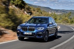 Picture of a driving 2018 BMW X3 M40i in Phytonic Blue Metallic from a front left perspective