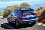 Picture of a driving 2018 BMW X3 M40i in Phytonic Blue Metallic from a rear left perspective