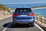 Picture of a driving 2018 BMW X3 M40i in Phytonic Blue Metallic from a rear perspective