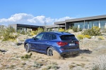 Picture of a driving 2018 BMW X3 M40i in Phytonic Blue Metallic from a rear left three-quarter perspective
