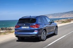 Picture of a driving 2019 BMW X3 M40i in Phytonic Blue Metallic from a rear right perspective