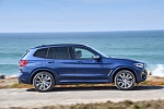 Picture of a driving 2019 BMW X3 M40i in Phytonic Blue Metallic from a right side perspective