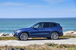 Picture of a driving 2020 BMW X3 M40i in Phytonic Blue Metallic from a left side perspective