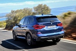 Picture of a driving 2020 BMW X3 M40i in Phytonic Blue Metallic from a rear left perspective