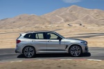 Picture of a driving 2020 BMW X3 M Competition in Donington Gray Metallic from a right side perspective