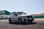 Picture of a driving 2020 BMW X3 M Competition in Donington Gray Metallic from a front right three-quarter perspective