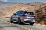 Picture of a driving 2020 BMW X3 M Competition in Donington Gray Metallic from a rear left three-quarter perspective