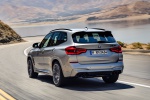 Picture of a driving 2020 BMW X3 M Competition in Donington Gray Metallic from a rear left perspective