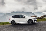 Picture of a driving 2020 BMW X3 xDrive30e PHEV AWD in Alpine White from a front right three-quarter perspective