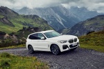Picture of a driving 2020 BMW X3 xDrive30e PHEV AWD in Alpine White from a front right perspective