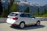 Picture of a driving 2017 BMW X5 xDrive50i in Alpine White from a rear right three-quarter perspective