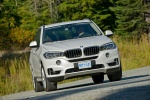 Picture of a driving 2017 BMW X5 xDrive50i in Alpine White from a front right perspective