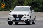 Picture of a driving 2017 BMW X5 xDrive50i in Alpine White from a front left perspective