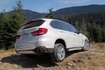 Picture of a driving 2017 BMW X5 xDrive50i in Alpine White from a rear right three-quarter perspective