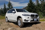 Picture of a driving 2017 BMW X5 xDrive50i in Alpine White from a front right three-quarter perspective