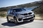 Picture of a driving 2017 BMW X5 M in Donington Gray Metallic from a front right three-quarter perspective
