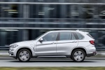 Picture of a driving 2017 BMW X5 xDrive40e in Glacier Silver Metallic from a side perspective