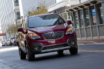 Picture of a driving 2016 Buick Encore in Winterberry Red Metallic from a frontal perspective