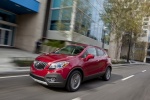 Picture of a driving 2016 Buick Encore in Winterberry Red Metallic from a front left three-quarter perspective