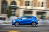 Picture of a driving 2017 Buick Encore in Coastal Blue Metallic from a side perspective