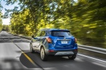 Picture of a driving 2017 Buick Encore in Coastal Blue Metallic from a rear left perspective