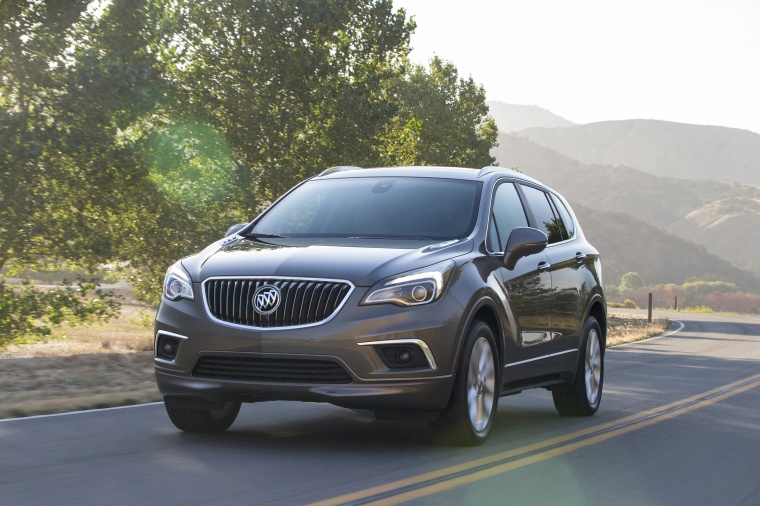 Picture of a driving 2017 Buick Envision AWD in Bronze Alloy Metallic from a front left perspective