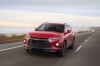 Picture of a driving 2019 Chevrolet Blazer RS AWD in Red Hot from a front left perspective