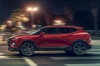 Picture of a driving 2020 Chevrolet Blazer RS AWD in Red Hot from a side perspective