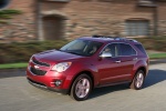 Picture of a driving 2015 Chevrolet Equinox LTZ in Crystal Red Tintcoat from a front left perspective