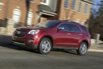 Picture of a driving 2015 Chevrolet Equinox LTZ in Crystal Red Tintcoat from a front left three-quarter perspective