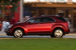 Picture of a driving 2015 Chevrolet Equinox LTZ in Crystal Red Tintcoat from a left side perspective