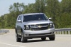 Picture of a driving 2015 Chevrolet Tahoe in Silver Ice Metallic from a front right perspective
