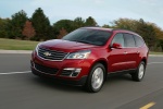 Picture of a driving 2014 Chevrolet Traverse LTZ AWD in Crystal Red Tintcoat from a front left three-quarter perspective
