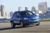 Picture of a driving 2015 Chevrolet Trax in Brilliant Blue Metallic from a front right three-quarter perspective