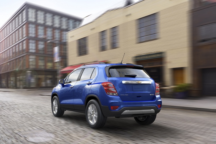 Picture of a driving 2018 Chevrolet Trax Premier in Blue from a rear left perspective