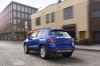 Picture of a driving 2019 Chevrolet Trax Premier in Blue from a rear left perspective