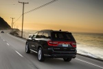 Picture of a driving 2016 Dodge Durango Citadel in Brilliant Black Crystal Pearlcoat from a rear left three-quarter perspective