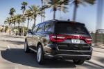 Picture of a driving 2016 Dodge Durango Citadel in Brilliant Black Crystal Pearlcoat from a rear left perspective