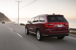 Picture of a driving 2016 Dodge Durango Limited AWD in Deep Cherry Red Crystal Pearlcoat from a rear left three-quarter perspective
