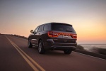Picture of a driving 2016 Dodge Durango R/T in Maximum Steel Metallic Clearcoat from a rear left three-quarter perspective