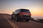 Picture of a driving 2017 Dodge Durango R/T in Maximum Steel Metallic Clearcoat from a rear left three-quarter perspective
