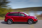 Picture of a driving 2019 Dodge Journey Crossroad AWD in Redline 2 Coat Pearl from a side perspective