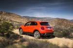 Picture of a driving 2016 Fiat 500X in Arancio from a rear left three-quarter perspective