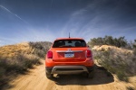 Picture of a driving 2016 Fiat 500X in Arancio from a rear perspective