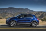 Picture of a driving 2016 Fiat 500X in Blu Venezia from a side perspective