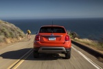 Picture of a driving 2016 Fiat 500X AWD in Arancio from a rear perspective