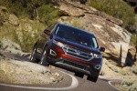 Picture of a driving 2017 Ford Edge Titanium from a front right perspective