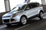 Picture of a driving 2015 Ford Escape Titanium 4WD in Ingot Silver Metallic from a front left three-quarter perspective