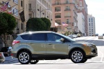 Picture of a driving 2015 Ford Escape Titanium 4WD from a right side perspective