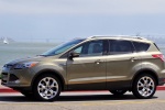 Picture of a driving 2016 Ford Escape Titanium 4WD from a left side perspective